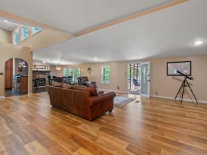 a living room with a couch and a table at Rocking W - Screened In Porch And Lakeside Fire Pit! in Double Springs
