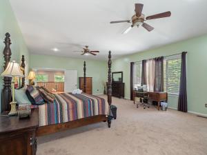 a bedroom with a bed and a ceiling fan at Rocking W - Screened In Porch And Lakeside Fire Pit! in Double Springs