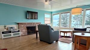 a living room with a couch and a fireplace at Saltwater Beach Home with Ocean View in Des Moines