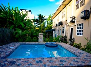 a swimming pool in a yard next to a building at Cozy one bedroom & Car rental apartment in Lambeau