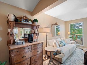 a living room with a couch and a dresser at Carols Cottage - Double Decker Dock! Popular Location! in Cullman