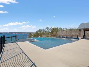 a swimming pool with a view of the water at Mallard Pointe 100 - Luxury Condo- Conveniently Located! in Cullman