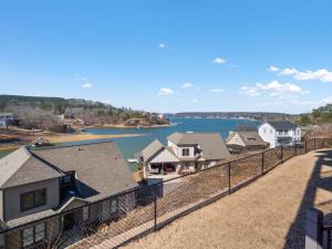 a view of a river with houses and a fence at Mallard Pointe 100 - Luxury Condo- Conveniently Located! in Cullman