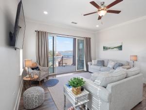 a living room with a couch and a ceiling fan at Mallard Pointe 100 - Luxury Condo- Conveniently Located! in Cullman