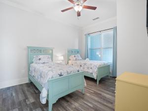 a bedroom with two beds and a ceiling fan at Mallard Pointe 100 - Luxury Condo- Conveniently Located! in Cullman +14 photos