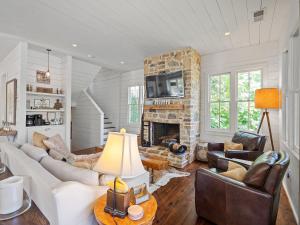 a living room filled with furniture and a stone fireplace at Central Perk - Pet Friendly, Luxury Cabin Feel, Kayaksand Coffee! in Crane Hill