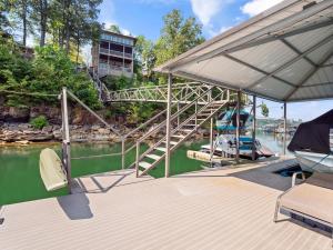 a dock with a boat on the water at Central Perk - Pet Friendly, Luxury Cabin Feel, Kayaksand Coffee! in Crane Hill