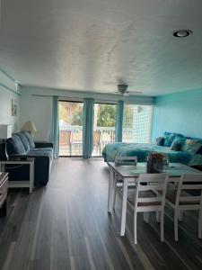 a bedroom with a bed and a table and a couch at Park Place Condo 227 in Cedar Key