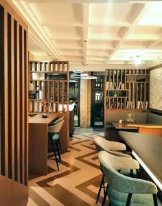 a bar with chairs and tables in a room at Lyo Hôtel - Centre Lyon Perrache in Lyon