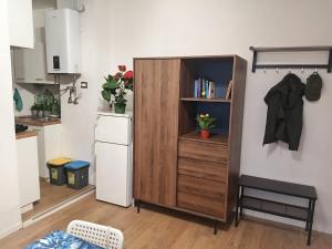 a kitchen with a wooden cabinet in a room at Lo Studio in Pioltello