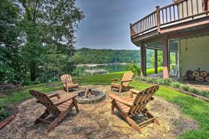 a group of chairs sitting around a fire pit at Cranes Nest - Huge Dock With Two Kayaks For The Guest's Use! in Crane Hill