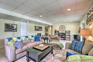 a living room with couches and a table at Cranes Nest - Huge Dock With Two Kayaks For The Guest's Use! in Crane Hill