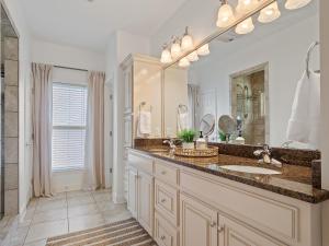 a bathroom with a sink and a large mirror at L & L Lodge - Six Bedrooms! Popular House And Location! in Double Springs +32 photos