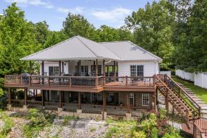 an image of a house with a large deck at Blessings Family Lodge- Amazing Sunsets, Amazing Views! in Houston