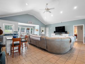 a kitchen and living room with a large couch at Blessings Family Lodge- Amazing Sunsets, Amazing Views! in Houston
