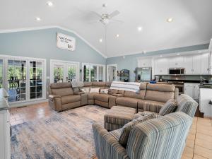 a living room with two couches and a kitchen at Blessings Family Lodge- Amazing Sunsets, Amazing Views! in Houston