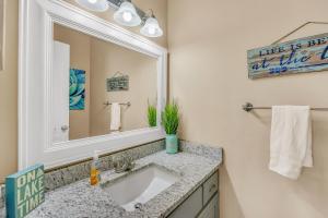 a bathroom with a sink and a mirror at Lake Therapy - Gazebo On The Lake, Easy Walk To The Water! in Crane Hill +32 photos