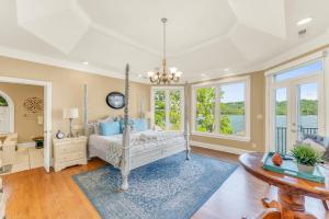 a bedroom with a bed and a table at Lake Therapy - Gazebo On The Lake, Easy Walk To The Water! in Crane Hill