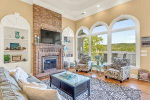 a living room with a couch and a fireplace at Lake Therapy - Gazebo On The Lake, Easy Walk To The Water! in Crane Hill