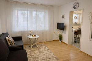 a living room with a couch and a table at Apartment Messe Karlsruhe in Rheinstetten