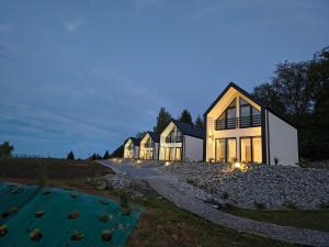 a row of houses on a hill at night at Domki nad jeziorem in Dobczyce