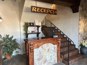 a lobby with a staircase with a sign that reads reggae at Zajazd Bachus in Dąbrowa Górnicza