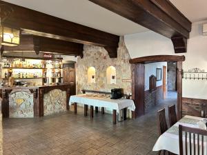 a restaurant with a white table and a counter at Zajazd Bachus in Dąbrowa Górnicza