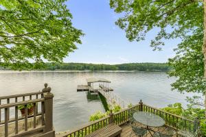 a house on the water with a dock at Nanas Lakehouse - Private Dock With Jet-Ski Port! in Jasper