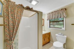 a bathroom with a toilet and a sink at Nanas Lakehouse - Private Dock With Jet-Ski Port! in Jasper +15 photos