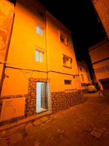 a yellow building with a window on the side of it at Dar La Madina Essaouira in Essaouira
