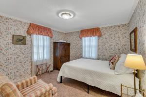 a bedroom with a bed and a chair at Nanas Lakehouse - Private Dock With Jet-Ski Port! in Jasper