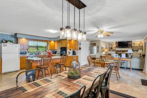 a kitchen and dining room with a table and chairs at Nanas Lakehouse - Private Dock With Jet-Ski Port! in Jasper