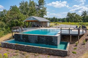 a swimming pool with a stone wall around it at Mallard Pointe Unit 200- Luxury Condo- Conveniently Located! in Cullman