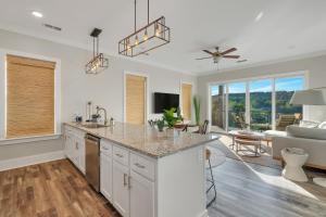 an open kitchen and living room with a couch at Mallard Pointe Unit 200- Luxury Condo- Conveniently Located! in Cullman