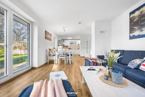 a living room with a couch and a table at Ferienhaus Ankerplatz St Peter-Ording in Böhl