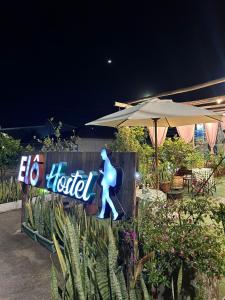 a sign for a hotel with a woman walking on it at Elô Hostel in Brasília