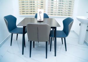 a table with chairs and a bag on top of it at Riverside Nest Owerri Ltd in Owerri