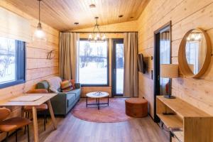 a living room with a couch and a table at Holiday Village Nuorgamin Lomakeskus in Nuorgam