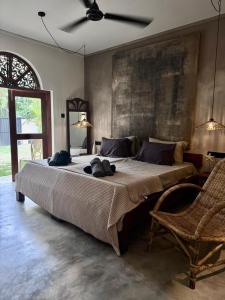 a bedroom with a large bed with a ceiling fan at Tara Luxury House in Habaraduwa Central +22 photos