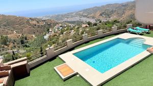 a swimming pool with a view of a mountain at LA CASA ROJA Casa privada con piscina y vistas Zona Torrox in Torrox