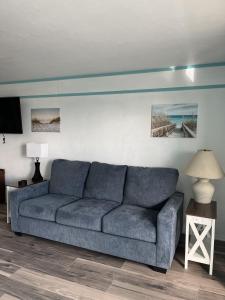 a living room with a blue couch in a room at Renovated Ocean-View Condo with Private Balcony in Cedar Key