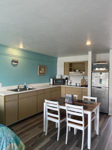 a kitchen with a table and chairs and a sink at Renovated Ocean-View Condo with Private Balcony in Cedar Key