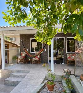 a patio with a hammock on a house at Casa do Aconchego - Quitinete I in Governador Celso Ramos