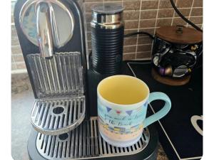 a coffee cup sitting on top of a coffee maker at The Beach House in Newry +17 photos