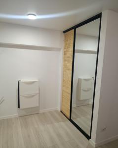 a mirror in a room with a white wall at Loft Like View in Izmail