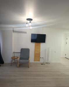 a room with a chair and a flat screen tv at Loft Like View in Izmail