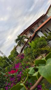 a building with a bunch of flowers in front of it at Pitaia 3 in Aracaju