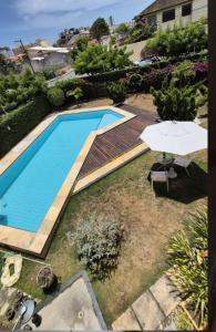 an overhead view of a swimming pool with an umbrella at Pitaia 3 in Aracaju