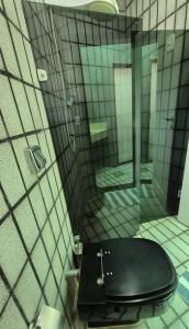 a bathroom with a black toilet in a shower at Pitaia 3 in Aracaju +25 photos