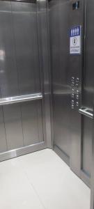 a metal elevator with a sign on the side of it at Edificio San Jose in Federación